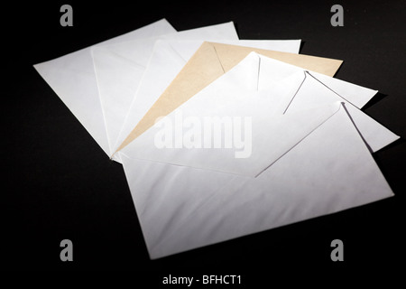 closed envelopes with white spot light on black background Stock Photo