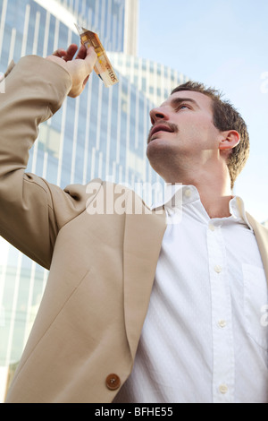 young businessman flying a money plane Stock Photo