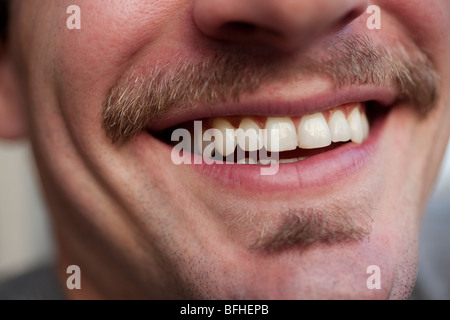 Close up on a toothy smile of a young man Stock Photo