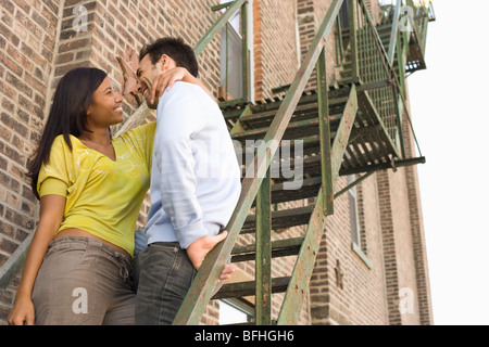 Young Couple on Fire Escape Stock Photo