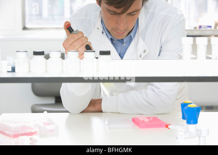 Scientist taking samples in laboratory Stock Photo