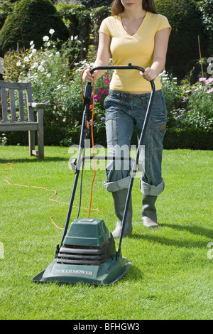 Woman Mowing Lawn Stock Photo