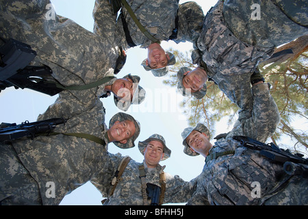 Low angle portrait of soldiers standing in circle Stock Photo