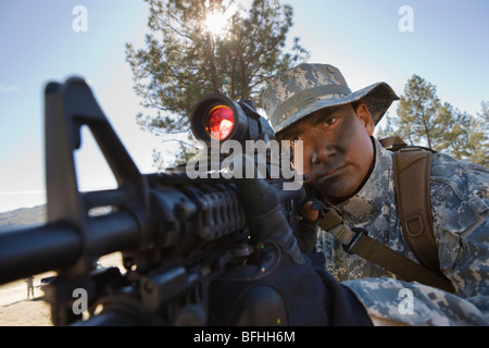 Soldier pointing rifle Stock Photo