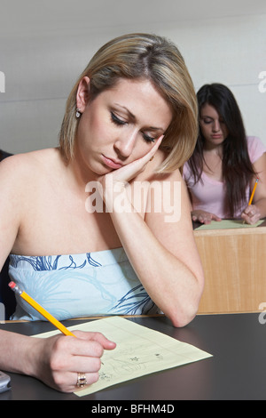 Female student working in class Stock Photo