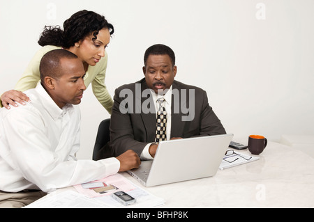 Couple and Accountant Using Laptop Stock Photo