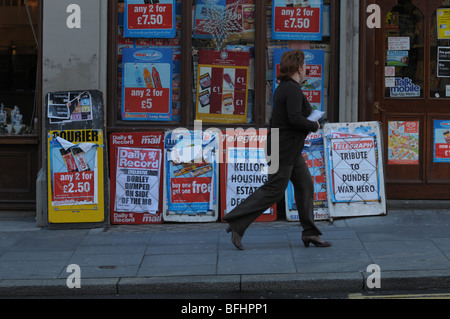 Newspaper headlines on advertising boards outside a newsagent. Stock Photo