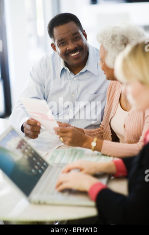 Financial Advisor Assisting Senior Couple Stock Photo