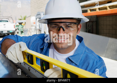 Workman Using a Spirit Level Stock Photo
