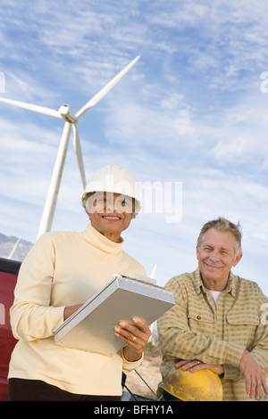 Couple working at wind farm Stock Photo