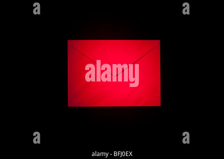 closed envelope with red spot light on black background Stock Photo