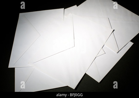 closed envelopes with white spot light on black background Stock Photo