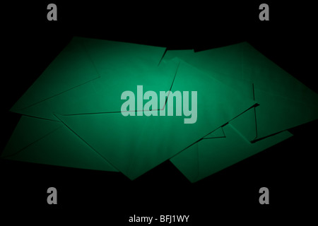 closed envelopes with green spot light on black background Stock Photo