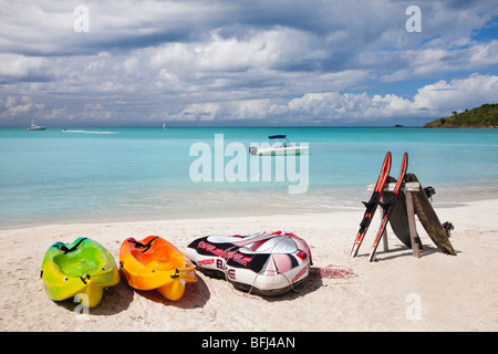 Water skis resting on a board and holiday styled kayaks, on the beach at Jolly Bay, Antigua, West Indies, Caribbean Stock Photo