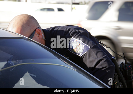 Nevada Highway Patrol State Trooper speaks to the driver of a car stopped for a traffic offence in Las Vegas. Stock Photo