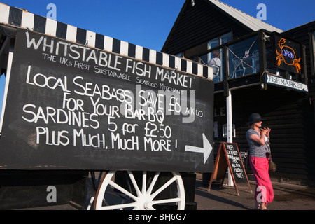 Woman in pink trousers at the fish market Whitstable Kent England Stock Photo