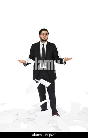 Businessman throwing paper around him. Stock Photo