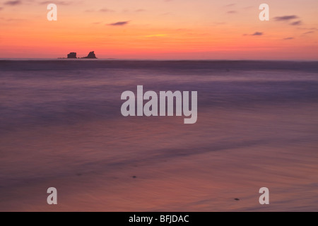 The sun sets over the Pacific Ocean along the coast of central Ecuador. Stock Photo