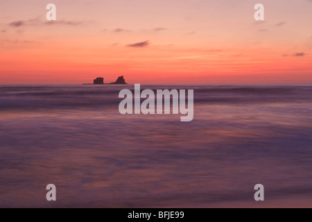 The sun sets over the Pacific Ocean along the coast of central Ecuador. Stock Photo