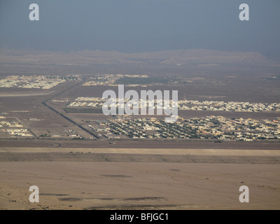 View from Jebel Hafeet mountain of single storey buildings and town in oasis town of Al Ain, UAE Stock Photo