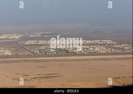 View from Jebel Hafeet mountain of single story buildings and town in oasis town of Al Ain, UAE Stock Photo