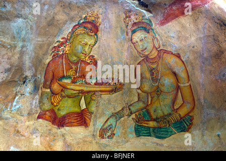 Ancient frescoes of maidens on cave wall at Sigiriya Rock Fortress, Sigiriya, Sri Lanka Stock Photo