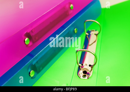 three multicolored folders, one folder is open. Closeup Stock Photo