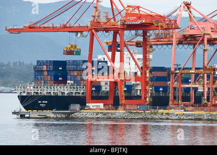 Cargo shipping containers are loaded onto a ship, Port of Vancouver, Canada. Stock Photo