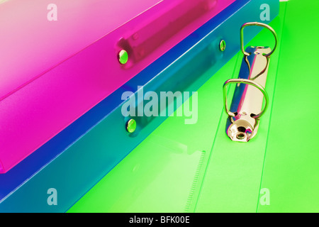 three multicolored folders, one folder is open. Closeup Stock Photo
