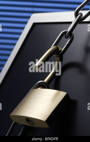 Chain and padlock on computer monitor close up Stock Photo