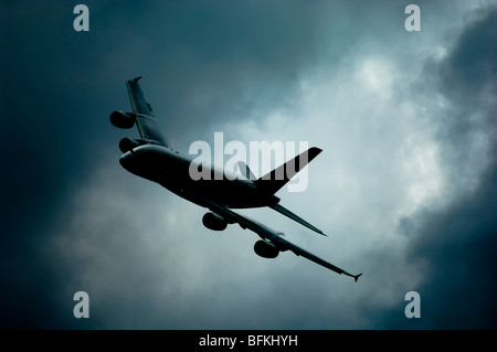 A commercial airliner Airbus Industrie Airbus A380 flying through stormy skies. Stock Photo
