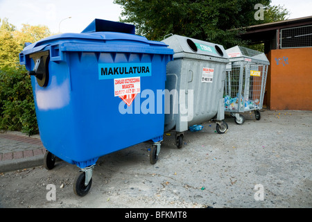 Recycling collection point for recycled paper, plastic bottles / bottle bank in a Polish car park. Poland. Stock Photo