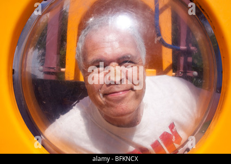 Storm chaser Tim Marshall presses his nose against the perspex of playground equipment in western Kansas, USA, June 10, 2009. Stock Photo