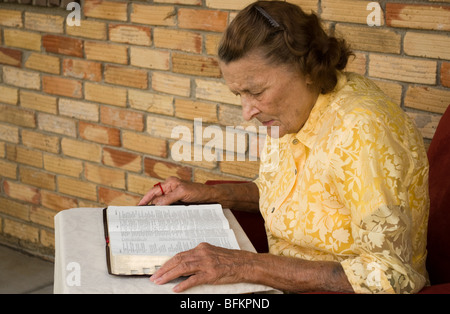 adult caucasion female reading an open Bible Stock Photo