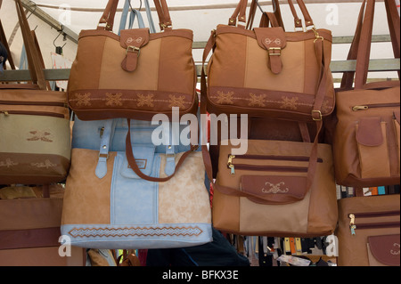 A display of leather handbags on a market stall Stock Photo