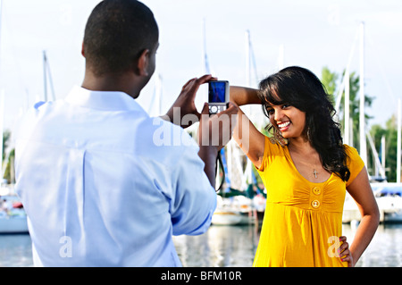 Beautiful woman posing for vacation photo at harbor Stock Photo