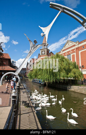 Empowerment Sculpture 2002, inspired by wind turbine blades, with Swans on River Witham, Waterside South, Lincoln Stock Photo