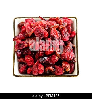 Bowl of dried cranberries isolated on white background Stock Photo