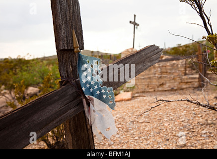 Old wooden grave crosses with weathered American flag Terlingua cemetery Texas USA Stock Photo