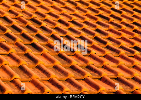 Closeup of red clay interlocking roofing tiles background Stock Photo
