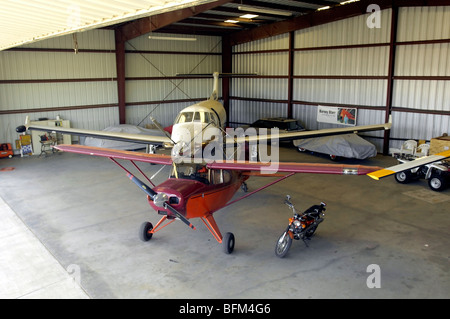 Two airplanes parked in a private aircraft hangar in Southern California Stock Photo