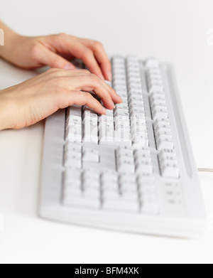 The grey computer keyboard and female hands working on it Stock Photo