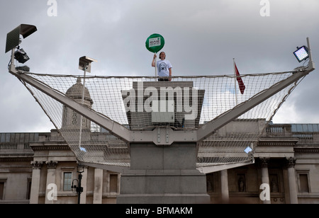 A man holding a banner as part of Antony Gormley's Fourth Plinth Project, London Stock Photo