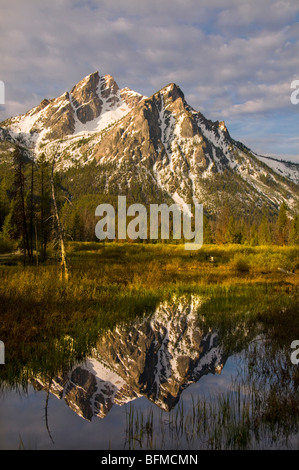 USA, IDAHO, Sawtooth National recreations Area, Sawtooth Mountains, Snow covered McGowen Peak reflecting in Stanley Lake Stock Photo