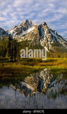 USA, IDAHO, Sawtooth National Recreation area, Sawtooth Mountains,  Snow covered McGowen Peak reflecting in Stanley Lake. Stock Photo