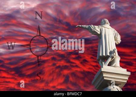 Statue of Christopher Columbus pointing west towards 'new world' set against red sky at sunset Stock Photo