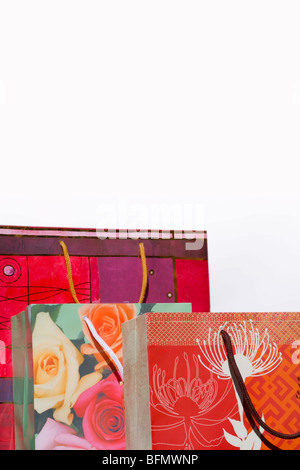 Three colourful shopping bags. Isolated. Copy space. Stock Photo