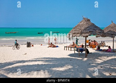 Tanzania, Zanzibar. Tourists sunbathe on Paje Beach, one of the finest white sandy beaches in the southeast of Zanzibar Island. Stock Photo