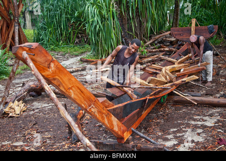 Tanzania, Zanzibar. Craftsmen build a dau, a wooden sailing boat commonly called a dhow, on Nungwi beach. Stock Photo