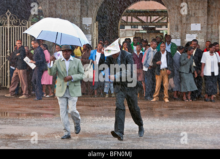 Kenya, Nairobi.  Commuters brave the rain at Nairobi Railway Station. Stock Photo